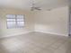 Inviting living room features tile floors, large window for natural light, and a bright, airy feel at 8503 N Willow Ave, Tampa, FL 33604