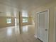 Open concept living room with tile flooring and neutral paint at 8503 N Willow Ave, Tampa, FL 33604