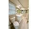 Bathroom featuring large vanity with a white countertop, ample storage, and well-lit mirror at 9005 Rainbow Ln, Port Richey, FL 34668