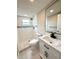 Modern bathroom featuring a walk-in shower, white vanity with a dark fixtures, and stylish mirror at 9005 Rainbow Ln, Port Richey, FL 34668