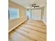 Bright bedroom with hardwood floors, neutral paint, ample natural light and closet with sliding doors at 9005 Rainbow Ln, Port Richey, FL 34668