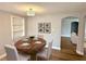 Elegant dining room featuring a stylish light fixture and round table with seating for four at 9005 Rainbow Ln, Port Richey, FL 34668