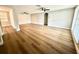 Large living area with new flooring, neutral paint, ceiling fans, and architectural arches at 9005 Rainbow Ln, Port Richey, FL 34668