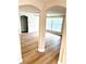 Open-concept living area with new floors, archways, and bright natural light from the windows at 9005 Rainbow Ln, Port Richey, FL 34668