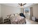 Cozy bedroom with a ceiling fan, window with curtains, and tiled floor at 9043 108Th Ave, Seminole, FL 33777