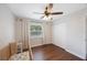 Welcoming Bedroom featuring a baby crib, a window with blinds, and closet doors at 9043 108Th Ave, Seminole, FL 33777