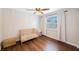 Bright Bedroom featuring a window with blinds, a baby crib, and a side table at 9043 108Th Ave, Seminole, FL 33777