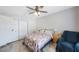 Comfortable bedroom featuring closet doors, a bed with a star patterned quilt, and side tables at 9043 108Th Ave, Seminole, FL 33777
