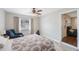 Bright bedroom featuring window with blinds, a bed with a patterned quilt, and an exit to the living room at 9043 108Th Ave, Seminole, FL 33777