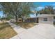 Quaint home features a covered front porch and well-maintained landscaping at 9043 108Th Ave, Seminole, FL 33777