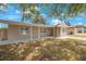 Inviting front exterior with a covered porch and neutral-toned facade at 9043 108Th Ave, Seminole, FL 33777