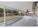 The home has a covered patio area overlooking the spacious backyard and mature trees at 9043 108Th Ave, Seminole, FL 33777