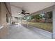 Relaxing covered patio with views of the private, fenced backyard and mature landscaping at 9043 108Th Ave, Seminole, FL 33777