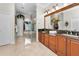 Well-lit bathroom with double vanities, a glass-enclosed shower, and a soaking tub at 9208 Brindlewood Dr, Odessa, FL 33556