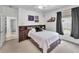 Cozy bedroom with a built-in bookshelf headboard and natural light from the window at 9208 Brindlewood Dr, Odessa, FL 33556