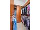 Walk-in closet with custom wood storage and shelving at 9208 Brindlewood Dr, Odessa, FL 33556