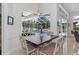 Dining area overlooking the pool, with a view of the outdoor space and abundant natural light at 9208 Brindlewood Dr, Odessa, FL 33556