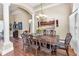 Dining room showcasing a wooden table with seating for six, lit by a modern chandelier at 9208 Brindlewood Dr, Odessa, FL 33556