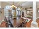 Elegant dining room with a large wooden table, seating for eight, and a stylish chandelier at 9208 Brindlewood Dr, Odessa, FL 33556
