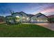 Stunning home featuring a well manicured lawn, brick paver driveway, and a fountain near the entrance at 9208 Brindlewood Dr, Odessa, FL 33556