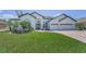 Stunning home featuring manicured lawn, mature palms, brick drive and a 3-car garage at 9208 Brindlewood Dr, Odessa, FL 33556