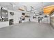 Well-organized garage with epoxy flooring, storage shelves, and ample space at 9208 Brindlewood Dr, Odessa, FL 33556