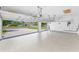 Clean, epoxy floor garage with insulated doors, and an organized wall of tools and accessories at 9208 Brindlewood Dr, Odessa, FL 33556