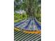 Inviting hammock featuring soft padding and tied between shady trees, ideal for backyard relaxation at 9208 Brindlewood Dr, Odessa, FL 33556