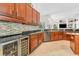 Well-appointed kitchen with dark wood cabinets, backsplash, stainless steel appliances, and granite countertops at 9208 Brindlewood Dr, Odessa, FL 33556