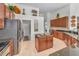 Spacious kitchen boasts wood cabinets, stainless steel appliances, and sleek countertops with an island at 9208 Brindlewood Dr, Odessa, FL 33556
