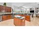 Open kitchen includes wood cabinets, granite counters, stainless appliances, and an island at 9208 Brindlewood Dr, Odessa, FL 33556