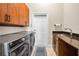 Laundry room featuring modern washer and dryer units and ample storage space at 9208 Brindlewood Dr, Odessa, FL 33556