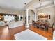 Open-concept living and dining area featuring hardwood floors, decorative columns, and ample seating at 9208 Brindlewood Dr, Odessa, FL 33556