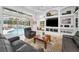 Bright living room with a clear view of the screened-in pool area and decorative built-in shelving at 9208 Brindlewood Dr, Odessa, FL 33556