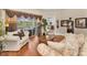 Spacious living room with a comfortable sofa, view of the pool area, and hardwood floors at 9208 Brindlewood Dr, Odessa, FL 33556