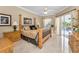 Elegantly appointed main bedroom featuring a luxury bed frame and access to the outdoor pool area at 9208 Brindlewood Dr, Odessa, FL 33556