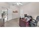 Bright home office with a ceiling fan, computer desk, and a view of the dining room at 9208 Brindlewood Dr, Odessa, FL 33556