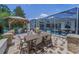 Outdoor dining area featuring covered grill, table and chairs, and a screened in porch at 9208 Brindlewood Dr, Odessa, FL 33556