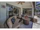 Covered patio with comfortable wicker furniture and sliding glass doors at 9208 Brindlewood Dr, Odessa, FL 33556