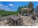 Charming patio with a gazebo, grill, and an outdoor seating area surrounded by lush landscaping at 9208 Brindlewood Dr, Odessa, FL 33556
