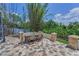The outdoor patio provides ample dining space with stone columns, brick pavers, and lush landscaping at 9208 Brindlewood Dr, Odessa, FL 33556