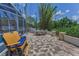 This patio offers a seating area near the pool, and dining area amid beautiful bamboo and lush landscaping at 9208 Brindlewood Dr, Odessa, FL 33556