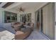 Comfortable covered patio with wicker furniture and ceiling fan, perfect for outdoor relaxation at 9208 Brindlewood Dr, Odessa, FL 33556