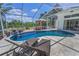 Inviting screened-in pool area with gazebo, lounge chairs, and serene backyard views at 9208 Brindlewood Dr, Odessa, FL 33556
