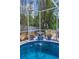 A decorative water fountain adds a touch of elegance to the screened-in backyard pool area at 9208 Brindlewood Dr, Odessa, FL 33556