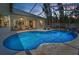 Sparkling pool with screened lanai, ample seating and lush landscaping for ultimate relaxation at 9208 Brindlewood Dr, Odessa, FL 33556