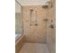 Modern shower features a multi-head system and neutral tile at 9208 Brindlewood Dr, Odessa, FL 33556