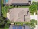 Overhead view of home, with mature trees, green lawn, patio with fire pit, and proximity to neighborhood amenities at 9317 Bella Vita Cir, Land O Lakes, FL 34637