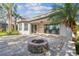 View of the backyard featuring paver patio and fire pit at 9317 Bella Vita Cir, Land O Lakes, FL 34637