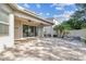 Exterior back view featuring large paver patio and fenced yard at 9317 Bella Vita Cir, Land O Lakes, FL 34637